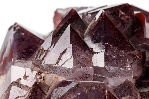 Macro mineral stone Amethysts Goethite Epidote on a white background