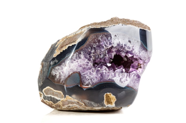 Macro Mineral Stone Amethysts in the rock on a white background