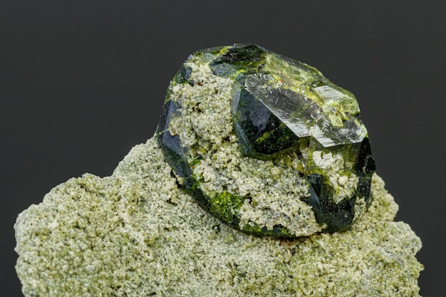 Macro mineral stone Andradite on a black background