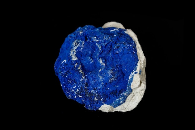 Macro mineral stone Azurite in siltstone against black background