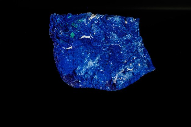 Macro mineral stone Azurite in siltstone against black background