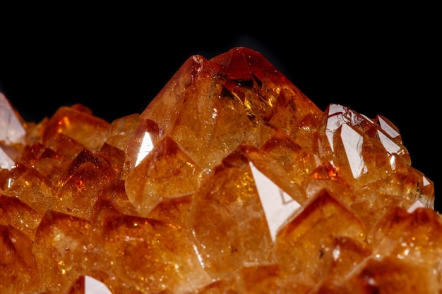 Macro mineral stone Citrine in rock in crystals on a black background