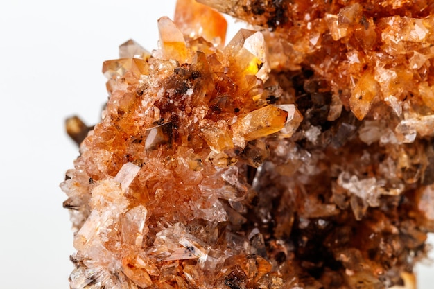 Macro of mineral stone Creedite on microcline on white background