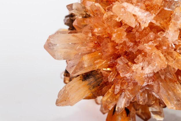 Macro of mineral stone Creedite on microcline on white background