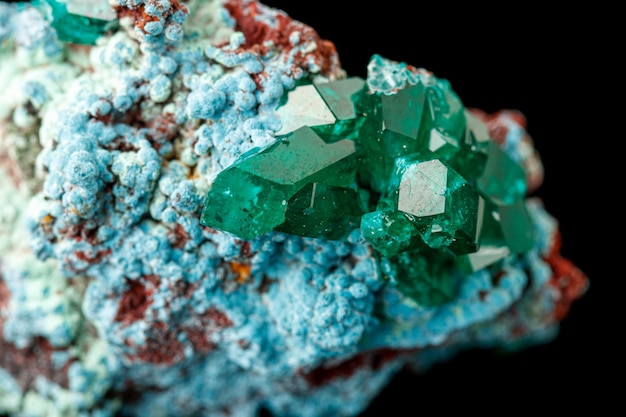 Photo macro mineral stone dioptase on a black background