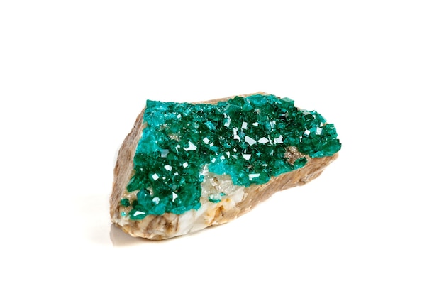 Macro mineral stone Dioptase silicate copper on a white background