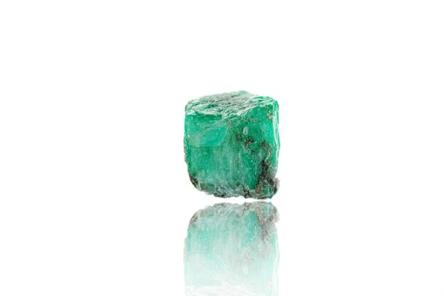 Macro mineral stone emerald on a white background