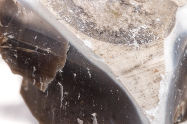 Macro mineral stone Flint in the rock on a white background