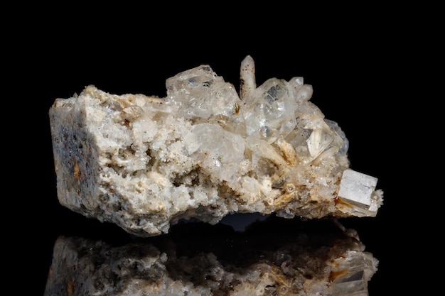 Macro mineral stone fluorite with quartz against black background