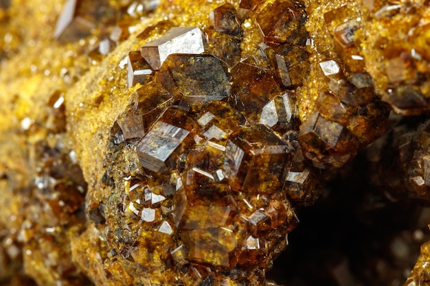 Macro mineral stone Garnet Green Garnet Epidote Grossular in the rock on a white background