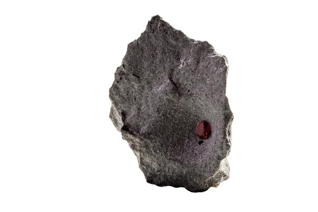 Macro mineral stone Garnet in rock on a white background