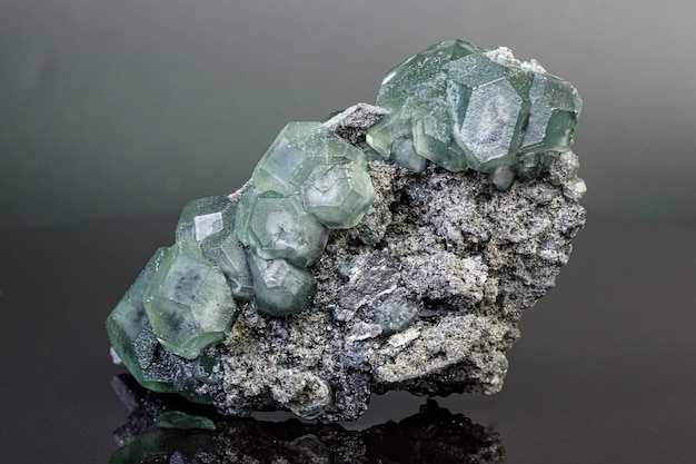 Macro mineral stone green fluorite on a black background