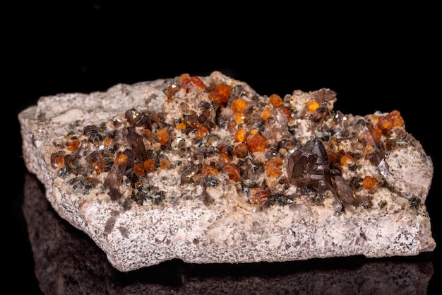 Macro mineral stone grossular garnet epidote on a black
background