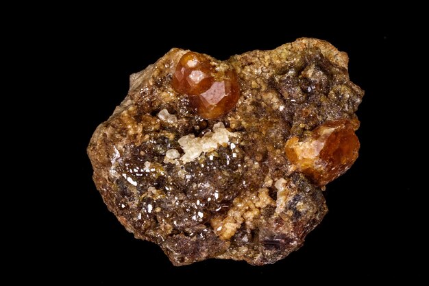 Macro mineral stone Grossular Garnet Epidote on a black background