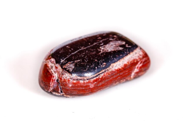 Macro mineral stone Jasper with hematite on a white background