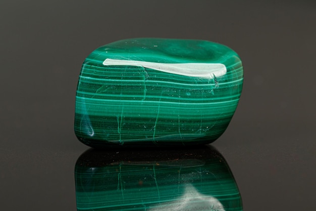 Photo macro mineral stone malachite on a black background