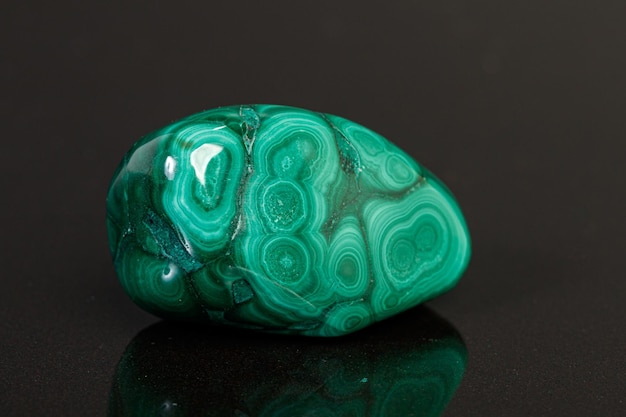 Macro mineral stone malachite on a black background