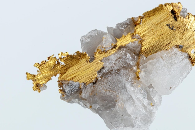 Macro mineral stone metal gold in quartz on a white background