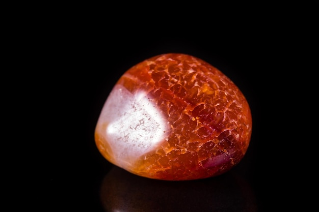 Macro mineral stone orange onyx on black background