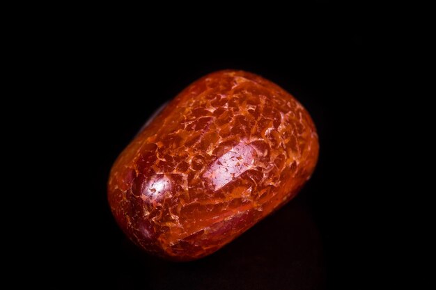 Macro mineral stone orange onyx on black background