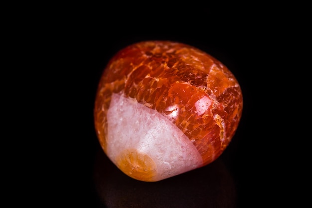 Macro mineral stone orange onyx on black background