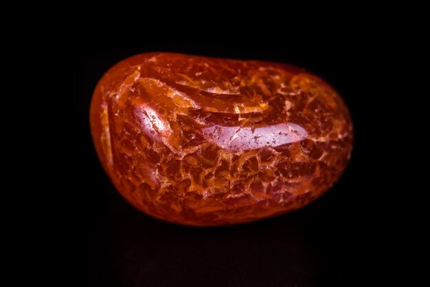 Macro mineral stone orange onyx on black background