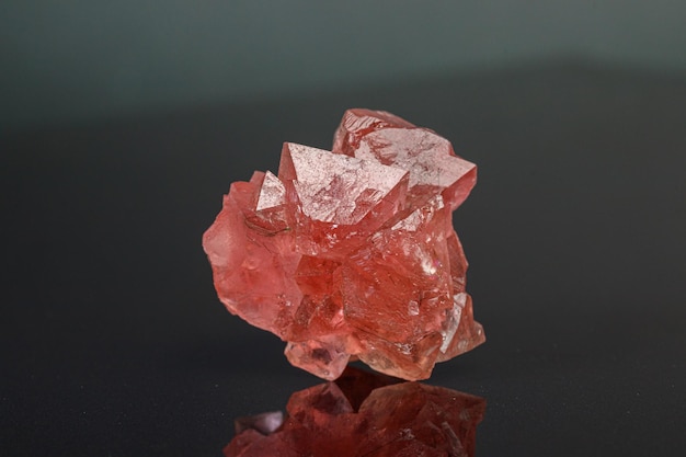 Macro mineral stone pink fluorite on a black background