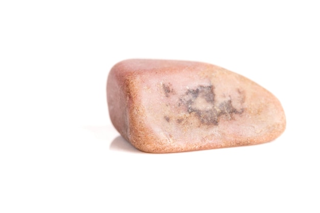 Macro mineral stone Pink quartz on a white background