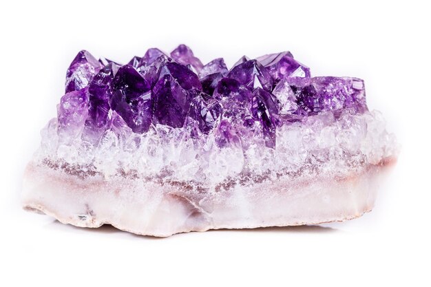 macro mineral stone purple amethyst in crystals on a white background