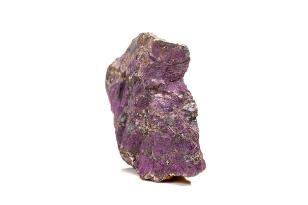 Macro mineral stone purpureus purple purpurite in the breed a white background