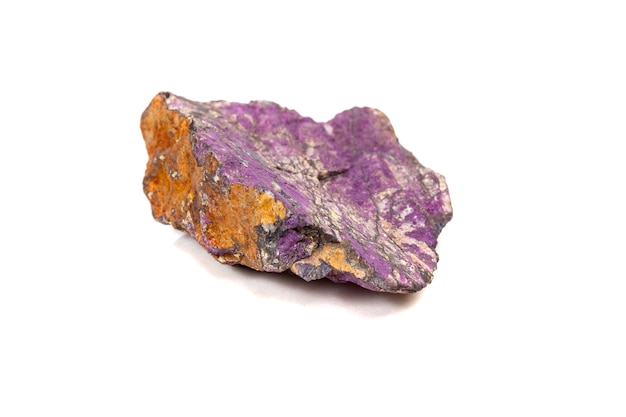 Macro mineral stone purpureus purple purpurite in the breed a white background