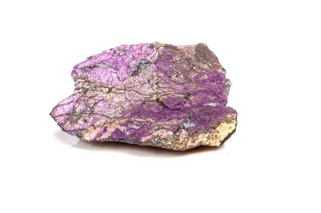 Macro mineral stone purpureus purple purpurite in the breed a white background