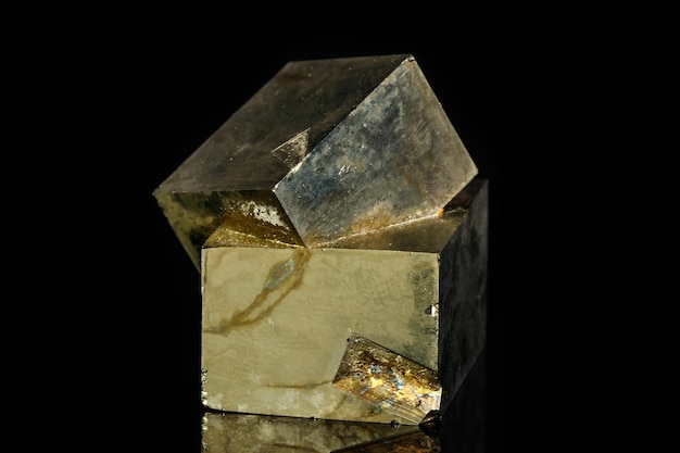 Macro mineral stone Pyrite on a black background