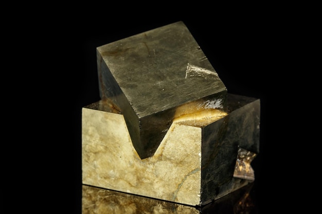 Macro mineral stone Pyrite on a black background