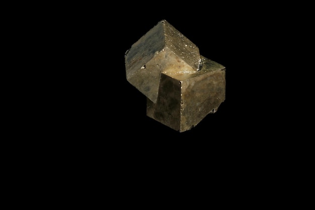 Macro mineral stone Pyrite on a black background