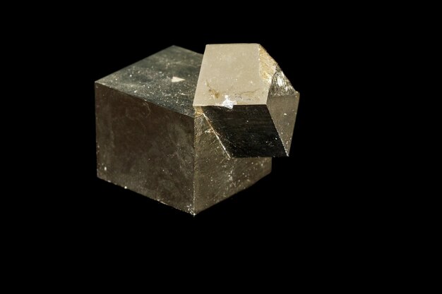 Macro mineral stone Pyrite on a black background