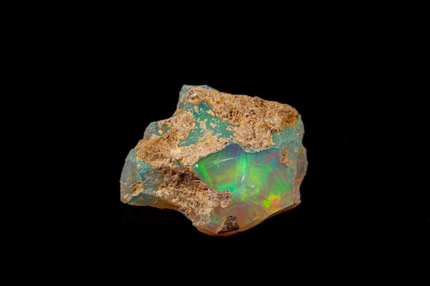 Macro mineral stone rare and beautiful opals on a black background