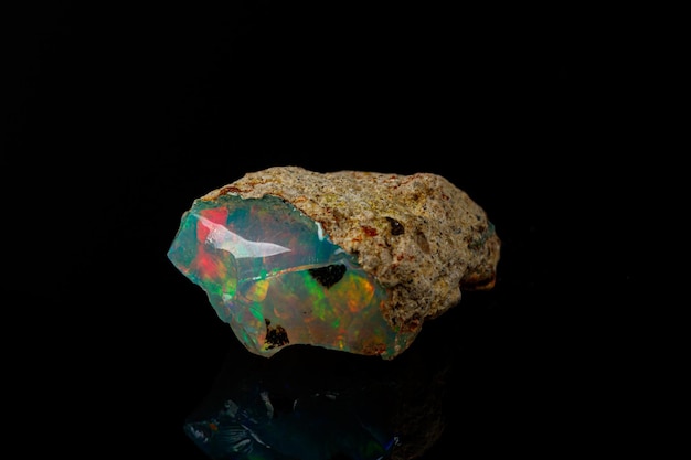 Macro mineral stone rare and beautiful opals on a black background