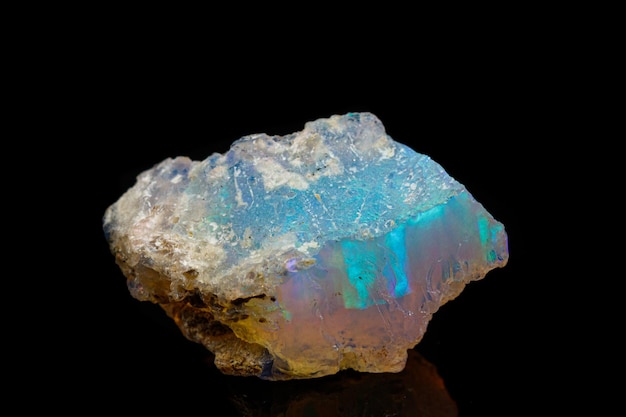 Macro mineral stone rare and beautiful opals on a black background