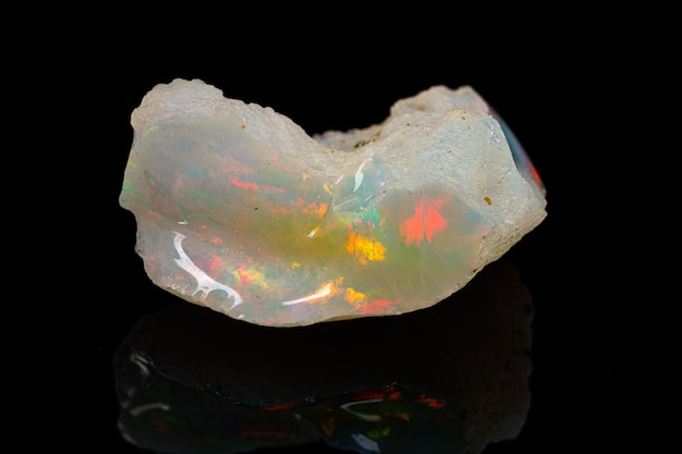 Macro mineral stone rare and beautiful opals on a black background