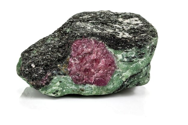 Macro of mineral stone ruby in rock on white background