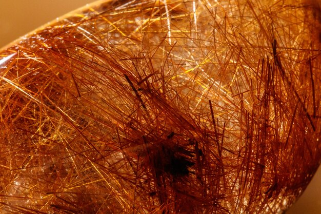 Macro mineral stone rutile in quartz on background