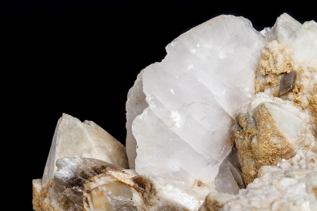 Macro mineral stone Snow quartz with calcite on a black background