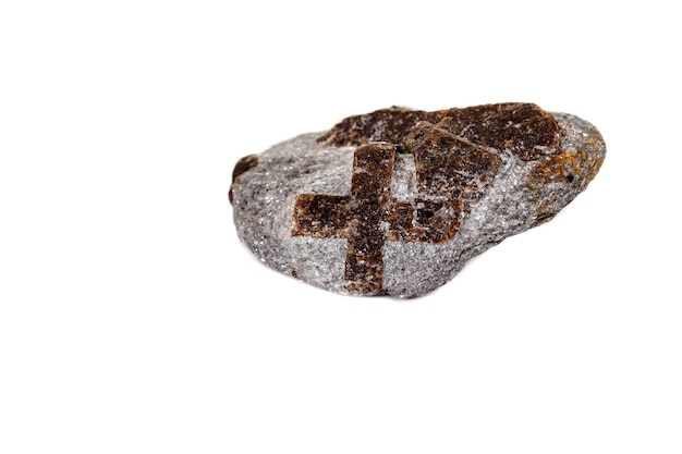 Macro mineral stone Staurolite on a white background