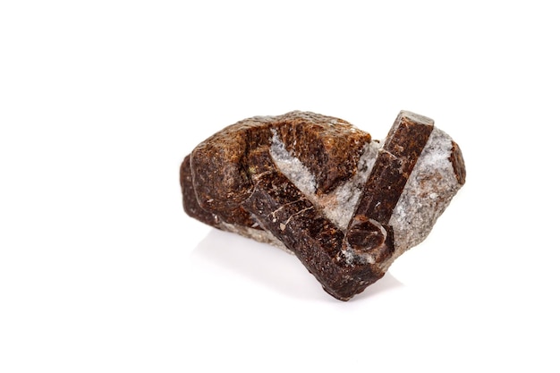 Macro mineral stone Staurolite on a white background