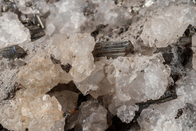 Macro mineral stone Stibnite quartz on a black background