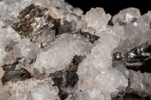 Macro mineral stone Stibnite quartz on a black background