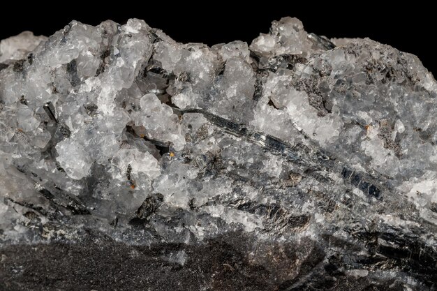 Macro mineral stone Stibnite quartz on a black background