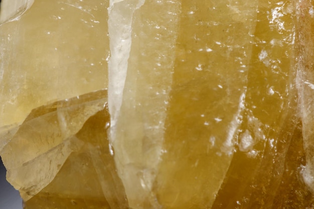 Macro mineral stone yellow Calcite on a black background