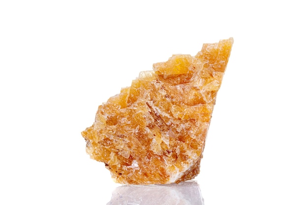 Macro mineral stone yellow calcite on a white background